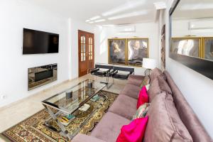 a living room with a couch and a glass table at CASA SAN MATIAS in Granada