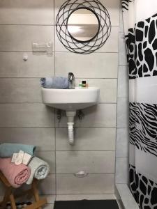 W łazience znajduje się umywalka i lustro. w obiekcie Dimitra's House w mieście Gómfoi