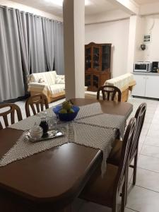 a dining room and living room with a table and chairs at Dimitra's House in Gómfoi