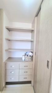 a walk in closet with white shelves and white drawers at Amplio y Residencial piso 9 in Cartagena de Indias