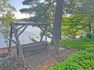 a wooden bench sitting next to a body of water at LakePlace Bed & Breakfast 