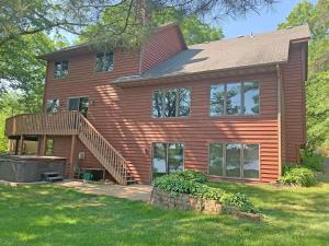 a large wooden house with a deck and stairs at LakePlace Bed & Breakfast 