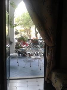 an open door to a patio with a table and chairs at B&B Albatros in Lipari +30 photos