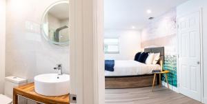a bathroom with a sink and a bed at The Lauderdale Boutique Hotel in Fort Lauderdale +91 photos