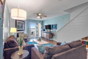 a living room with two couches and a table at Mariners Cay 68 in Folly Beach