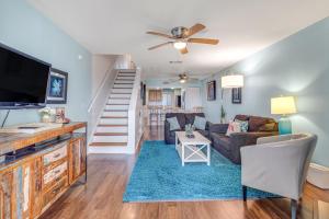 a living room with a couch and a tv at Mariners Cay 68 in Folly Beach +41 photos