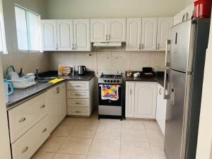 a kitchen with white cabinets and a black and white stove at Peruvian House - Miraflores in Lima