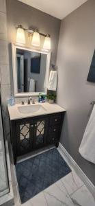 a bathroom with a sink and a mirror at 12- Exec 1BD-Wifi-AC-Workspace in Windsor