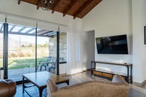 ein Wohnzimmer mit einem Sofa und einem Tisch in der Unterkunft Los Alerces Resort, Hotel & Spa in San Andres de las Sierras