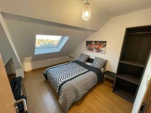 En eller flere senge i et værelse på Belfort Appartement confort