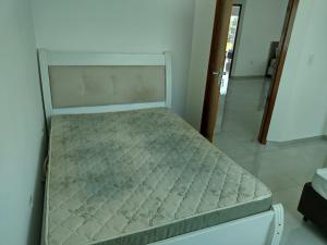 a small bed in a room with a mattressvisor at Casa próxima ao Santuário de Aparecida in Aparecida