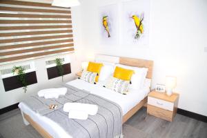 a bedroom with a large bed with yellow pillows at Manchester Apartments by BEVOLVE - Free Parking in Manchester