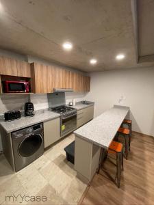 a kitchen with a stove and a counter top at Spacious and cozy apartment in Mexico City in Mexico City