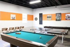 a billiard room with two ping pong tables at Pickleball Court - Walk to AT&T Stadium, Globe Life, Six Flags, Texas Live! & more in Arlington