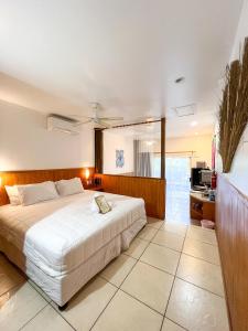 a bedroom with a large white bed in a room at Castaway Resort in Rarotonga