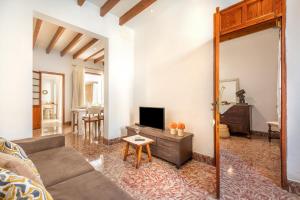 a living room with a couch and a tv at Ca na Francesca in Pollença