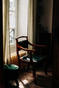a chair sitting in a room next to a window at La Maison de Laulie in Bagnères-de-Bigorre