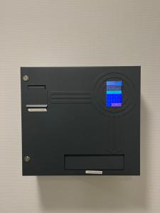 a black safe with a screen on a wall at Longhouse Aparthotel in Dreieich