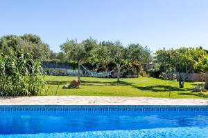 a view of a yard with a swimming pool at Can Nin in Santanyi