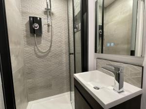 a bathroom with a sink and a shower at Lovely 1 Bed Studio 1B near Royal Infirmary and DMU in Leicester