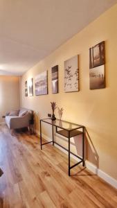 a living room with a glass table and a bed at Apartamento en el casco historico de Betanzos in Betanzos