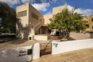 a building with a fence in front of it at Can Noves - Villa de 3 Suites in Sant Francesc Xavier