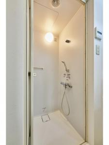 a shower with a shower head in a bathroom at Kyoto Hostel family room / Vacation STAY 8181 in Nishinotōindōri