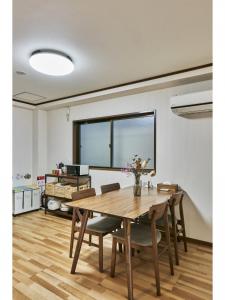 a dining room with a wooden table and chairs at Kyoto Hostel family room / Vacation STAY 8181 in Nishinotōindōri