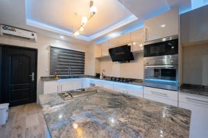 a kitchen with a granite counter top in a room at Luxurious 3 Bedroom Apartment at Victoria Island in Lagos