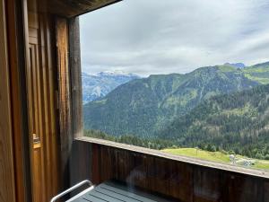 a room with a window with a view of mountains at Arve et Giffre Samoens 1600 in Samoëns