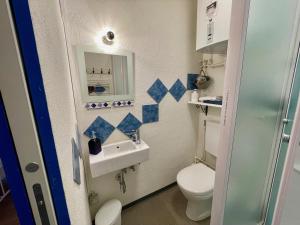 a small bathroom with a toilet and a sink at 1912 - Blue Room - old town in Locarno