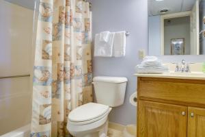 a bathroom with a toilet and a shower curtain at Walk to Ocean City Beach Condo with Rooftop Deck in Ocean City +20 photos
