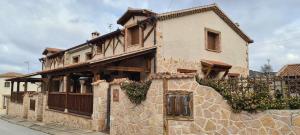a stone building with a fence in front of it at Casas Rurales Hoces del Duratón in Carrascal del Río