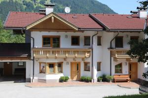 a large house with a red roof at Haus Andrea Schiestl in Zell am Ziller
