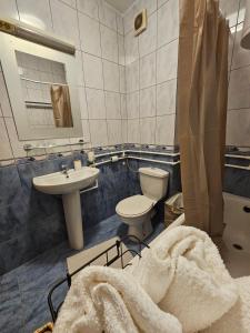 a bathroom with a toilet and a sink and a tub at Apartman Lollita in Banja Luka