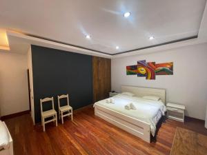 a bedroom with a bed and a painting on the wall at Patio del Puerto Hotel Boutique in Puerto Rico