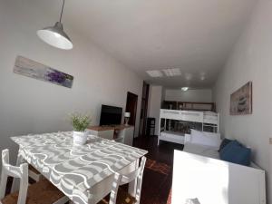 a living room with a table and a couch at Residence Casa Pineta in Principina a Mare +46 photos