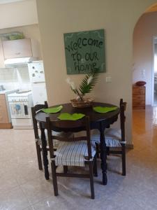 a table with a plant on it in a kitchen at Φιλόξενο σπίτι στο Λουτράκι! in Loutraki