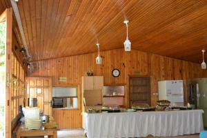 a large kitchen with a table in a wooden room at Olympos Doga Pansiyon in Olympos