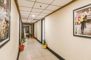 an empty hallway in an office building with potted plants at Collection O Limewood Stay in Gurgaon