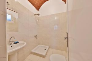 a white bathroom with a toilet and a sink at El Hanna Valley View in Luxor