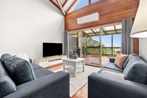 a living room with two couches and a television at Bells Rest with a view in Kurrajong