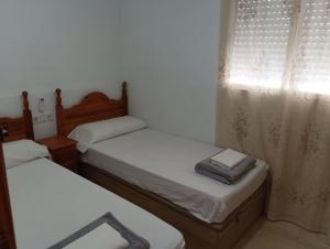 Łóżko lub łóżka w pokoju w obiekcie Holiday Apartment Torres Montecarlo