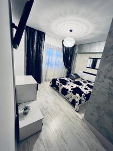 a bedroom with a bed with a black and white cow at GRAY APARTAMENT in Craiova
