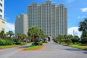 a large building with palm trees in front of a street at Ariel Dunes I 1709 in Destin