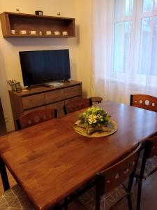 a dining room table with a plate of flowers on it at Apartmán Nad řekou in Vejprty