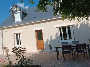 a table and chairs in front of a house at Comme à la maison prés des châteaux de la Loire in Feings