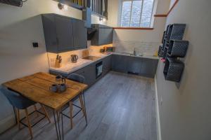 an overhead view of a kitchen with a wooden table at Boutique Penthouse Apartment in Historic Hull HU1 - sleeps 6 in Hull
