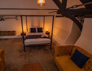 a bedroom with a bed and a couch at Boutique Penthouse Apartment in Historic Hull HU1 - sleeps 6 in Hull +11 photos