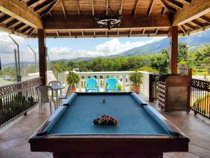 a pool table on a patio with a view at Finca Sanfelipe in Calima